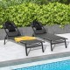 Black patio sunbathing lounge chairs with adjustable backrests and pillows, perfect for poolside relaxation.