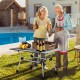 Folding heavy-duty aluminum camping table with adjustable height, set up for outdoor cooking by the pool.