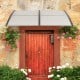 Gray outdoor front door awning with sturdy PC hollow panels for sunlight, rain, and snow protection.