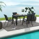 Four brown patio rattan dining chairs with wicker seats around a table, perfect for outdoor dining in the backyard.