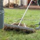 Close-up of the aluminum rake's sharp tines and sturdy handle, designed for efficient lawn care and easy handling.