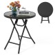 Round black folding side table with tempered glass top, ideal for indoor and outdoor use, lightweight and easy to store.