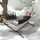 Multicolor hammock with stand, featuring breathable fabric and wood spreader bar, perfect for relaxing in the backyard.
