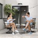 Two people enjoying coffee on 2 pieces patio swivel dining chairs with blossom pattern backrest and cushions in black.