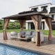 Double-roof patio gazebo with galvanized steel roof, curtains, and netting, perfect for outdoor relaxation by the pool.