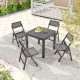 Expandable grey patio dining table with slatted top and four folding chairs, perfect for outdoor gatherings.
