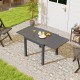 Expandable grey patio dining table for 4-6 people, featuring a slatted top and sturdy aluminum construction.