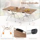 Folding camping table with wood-grain tabletop and aluminum legs, featuring side handles for easy transport and.