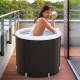 Outdoor ice plunge tub with lid, featuring thick insulation and inflatable outer ring for comfort and support on a.
