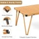 Folding camping table with a waterproof brown surface, sturdy frame, and triangular support for picnics and camping.