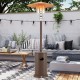 Brown 50000 BTU propane patio heater with round table design, providing 360° heat coverage for outdoor gatherings.