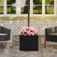 Black 2-in-1 outdoor umbrella base planter with pink flowers, designed for stability and style in patio settings.