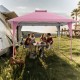 Pink 13 x 13 ft pop-up gazebo providing shade for outdoor gatherings, featuring extended eaves and sturdy support.