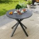 Round patio bistro table with wood-like top and X-shaped legs, perfect for outdoor gatherings in the garden.
