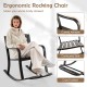 Patio rocking chair with footrest, curved armrests, and floral backrest design for backyard relaxation.