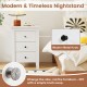 Modern white nightstand with three drawers, featuring a stylish design and space-saving storage for bedroom decor.