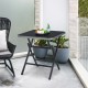 Folding square dining table with aluminum frame and tempered glass top, perfect for patio or indoor use.