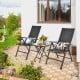 Folding patio side table with tempered glass tabletop, featuring a powder-coated steel frame, ideal for outdoor use.