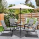 Patio dining set featuring four stackable cushioned chairs and an umbrella, ideal for outdoor relaxation and dining.