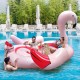 Inflatable flamingo floating island for 4-6 people with 6 cup holders, perfect for pool parties and relaxation.