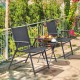 Two gray folding chairs and a coffee table in an outdoor setting, perfect for garden relaxation and easy storage.