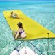 Two women enjoying the 3 Layer Floating Water Pad Foam Mat in vibrant yellow on clear water, perfect for summer fun.