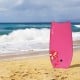 Bright pink lightweight bodyboard with floral design on the beach, featuring durable EPS core and leash for safe.
