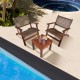 Two armchairs and a wooden table from the 3 Pieces Outdoor Wooden Patio Rattan Furniture Set, perfect for poolside.