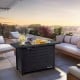 Rectangular 42-inch propane fire pit table in dark gray with lava rocks, perfect for outdoor warmth and style.