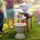 Rattan cooler bar table with retractable tabletop, 8-gal capacity, ideal for outdoor parties and barbecues.