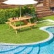Rectangular 6-person picnic table set in natural wood, featuring two built-in benches and an umbrella hole, ideal for.