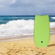 Lightweight green bodyboard with leash on a sandy beach, designed for small and medium waves, perfect for summer fun.
