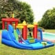 Inflatable bounce house splash pool with water slide, featuring safety fence and vibrant colors for outdoor fun.
