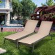 Pair of outdoor reclining chaise lounge chairs in brown with adjustable backrest, perfect for garden or backyard.