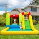 Brightly colored outdoor inflatable bounce house with slide, suitable for gardens and parks, made of durable Oxford.