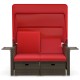 Outdoor patio rattan daybed with red cushions, retractable canopy, and adjustable backrests for backyard relaxation.