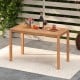 Outdoor acacia wood dining table with slatted tabletop, accommodating 4-6 people, perfect for patio or garden use.