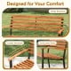 Close-up of the acacia wood outdoor bench showing the wide backrest, curved armrests, and contoured seat for comfort.