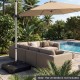 Square water and sand fillable umbrella base with wheels, designed for 8-12 ft cantilever umbrellas, shown outdoors.