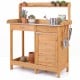 Outdoor garden wooden work station potting bench with a large metal tabletop and storage drawer for gardening tasks.