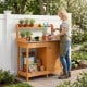 Outdoor garden wooden potting bench with a large metal tabletop, big drawer, and removable lower shelf for gardening tasks.