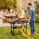 Portable outdoor grill cart with large directional wheels, ergonomic handle, and ample storage for a seamless cooking experience.