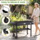 Foldable outdoor grill cart with a 31” x 17” tabletop, ergonomic handle, and lockable wheels for easy transport and storage.