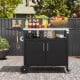Outdoor grill cart with a stainless steel top and side table, featuring storage space and convenient accessories for.
