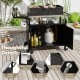 Outdoor grill cart with stainless steel top, storage shelves, and convenient features like a bottle opener and paper.