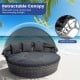 Outdoor PE wicker round daybed with retractable canopy and gray cushions, ideal for backyard relaxation and sun.
