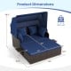 Outdoor patio rattan daybed with retractable canopy, navy cushions, and side tables, ideal for backyard relaxation.