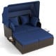 Outdoor patio rattan daybed with retractable canopy and navy cushions, featuring side tables for added convenience.