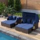Outdoor patio rattan daybed with retractable canopy and navy cushions, perfect for poolside relaxation and comfort.