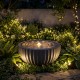 Outdoor round sphere water fountain with LED lights, featuring a realistic stone look, perfect for tranquil garden.